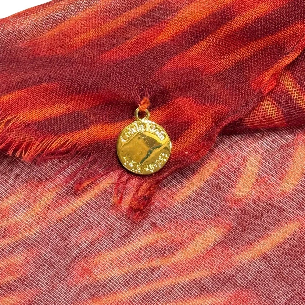 Calvin Klein Lightweight Scarf Red Orange Pattern Fringe Hem Gold Logo Charm